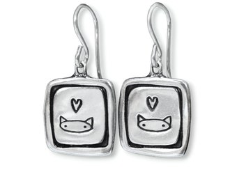 May include: Silver dangle earrings with a square charm featuring a cartoon cat with a heart above it.