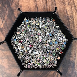 May include: A large collection of silver-toned modular link charms featuring various colorful enamel designs, symbols, and patterns, all contained within a black hexagonal tray with snap-button corners for storage and organization.