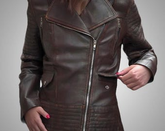May include: A dark brown leather motorcycle jacket featuring an asymmetrical silver-tone metal zipper closure, a wide notched collar, zippered chest pockets, flap pockets at the waist, and quilted textured detailing on the sleeves and hem.