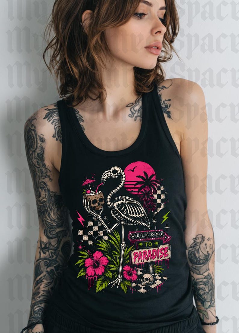 May include: Black tank top featuring a skeleton flamingo holding a skull cocktail, with a pink sunset and palm trees. The graphic includes the text "WELCOME TO PARADISE" and pink hibiscus flowers.