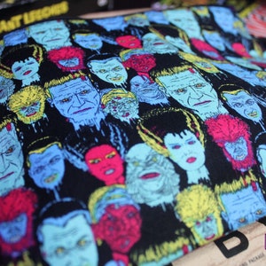 Custom-made Universal Horror Monsters pouch. All over print of The Bride of Frankenstein, Frankenstein, Dracula, Wolfman, The Mummy and Creature from the Black Lagoon. Polka dot lining, zipper closure and grommet strap on the side.