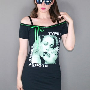 Off shoulder dress Type O Negative shirt, modified for a flattering female fit and style. This dress has black insertion lace on the shoulder with green, satin ribbon. Ribbon can be adjusted for a different look or removed. Black lace on the hem.