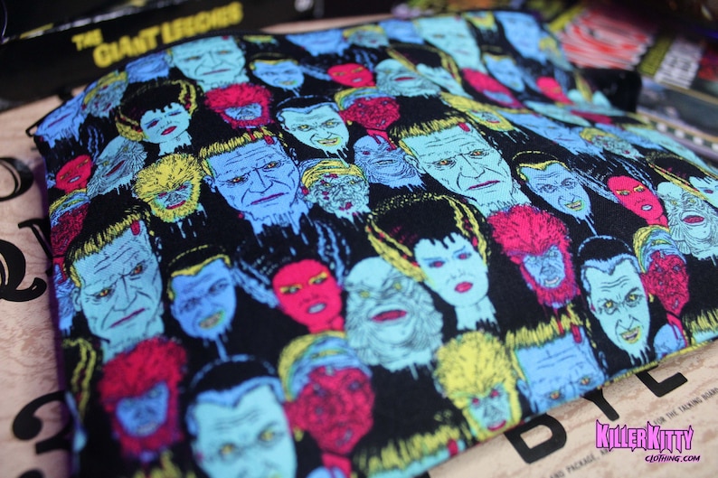 Custom-made Universal Horror Monsters pouch. All over print of The Bride of Frankenstein, Frankenstein, Dracula, Wolfman, The Mummy and Creature from the Black Lagoon. Polka dot lining, zipper closure and grommet strap on the side.