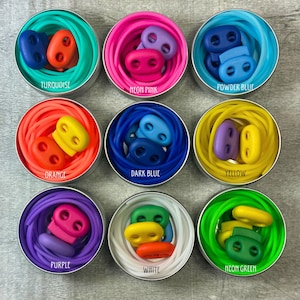 May include: Nine small round containers each holding a different colour of elastic cord and a pair of plastic cord locks. The colours are turquoise, neon pink, powder blue, orange, dark blue, yellow, purple, white, and neon green.