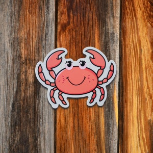 May include: A cartoon illustration of a red crab with a white shell and black eyes. The crab is smiling and has its claws raised.