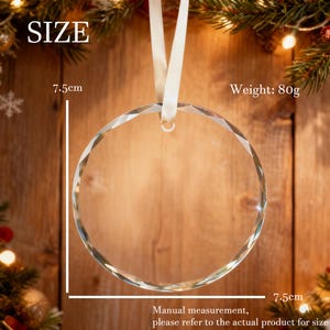 May include: A clear, circular glass ornament with faceted edges, suspended by a white ribbon. The ornament measures 7.5 cm in diameter and weighs 80 grams. The text "SIZE" is visible at the top left, and "Weight: 80g" is at the top right.