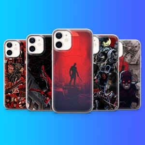 May include: Five clear smartphone cases featuring various Daredevil comic book illustrations. The designs include a red silhouette, action scenes, and character portraits in black, red, and white. Each case has a dual camera cutout on the top left.