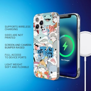May include: A clear phone case featuring a colorful cartoon shark design with the text "It's Jeff". The phone case is shown next to a phone with a charging screen. The case supports wireless charging and has a raised bumper.