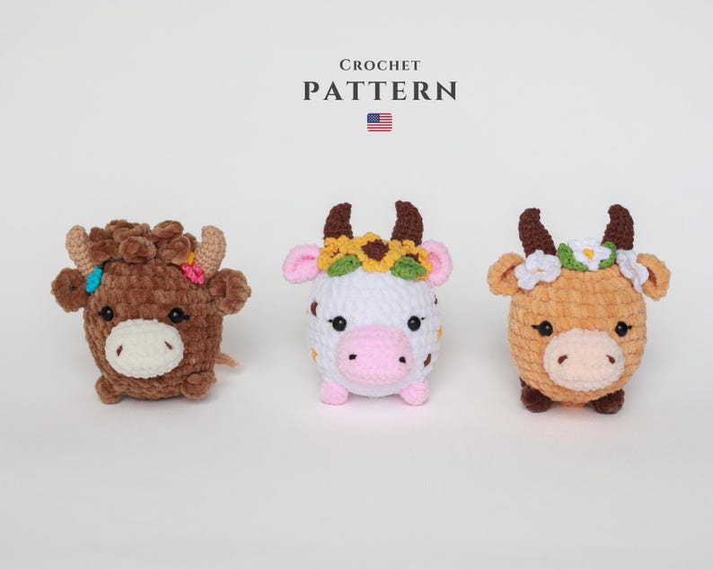 May include: Three crochet cow plushies in brown, white, and tan, each with a unique floral crown. The text "CROCHET PATTERN" is above the cows, with a small American flag. These handmade stuffed animals are perfect for a nursery.