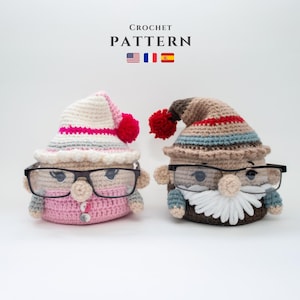 May include: Two crocheted gnome-like figures with glasses. The figure on the left is wearing a pink and white hat with a pink and white striped band. The figure on the right is wearing a brown and blue hat with a red and white striped band. Both figures have white beards.