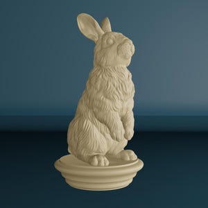 May include: A beige rabbit statue, sculpted with detailed fur texture, stands upright on a tiered base. The rabbit has long ears and is posed in a seated position. The background is a gradient of blue.