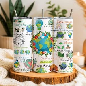 May include: Three white stainless steel tumblers with lids and straws. Each tumbler features colorful illustrations and text related to environmental protection, including the Earth, flowers, and phrases like "Protect Earth" and "Think Green."