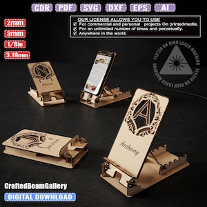 May include: Wooden phone stands with personalized names and decorative designs. The stands are made of light-colored wood and feature laser-cut details. One stand holds a phone. The text "CraftedBeamGallery" and "DIGITAL DOWNLOAD" are visible.
