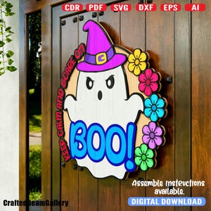 May include: A digital download of a Halloween door hanger featuring a ghost wearing a purple witch hat with the text "Keep Calm and Scare On" and "Boo!" in a blue circle. The ghost is surrounded by colorful flowers.