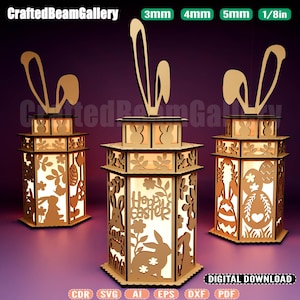 May include: Three wooden Easter lanterns with bunny ear toppers. The lanterns feature cut-out designs of bunnies, eggs, and floral patterns. The center lantern has the text "Happy Easter". The image also includes text indicating digital download formats.