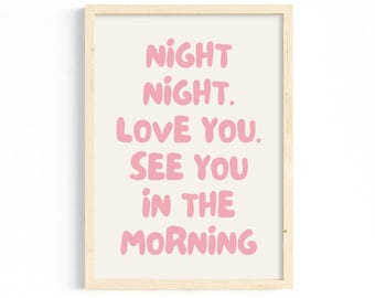 May include: A framed print with the words "NIGHT NIGHT. LOVE YOU. SEE YOU IN THE MORNING" in pink bubble letters on a cream background. The frame is a light wood color.