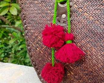 Festive Fusion: Handcrafted Red and Green Pom Pom Tassel Bag Hanger, unique boho hanging bag charm