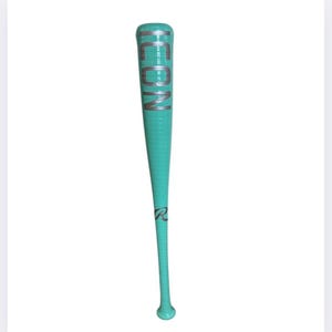May include: A teal baseball bat with the word "ICON" in silver lettering. The bat has a textured grip and the Rawlings logo near the bottom. The bat is set against a white background.