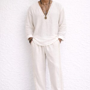 May include: Off-white linen shirt and pants set. The long-sleeved shirt has a V-neck with lace trim. The pants have a straight leg with lace detailing. The text "Iron Will BOUTIQUE" is in the upper right corner. The text "You can make this shirt and pants as a matching set" is at the bottom.