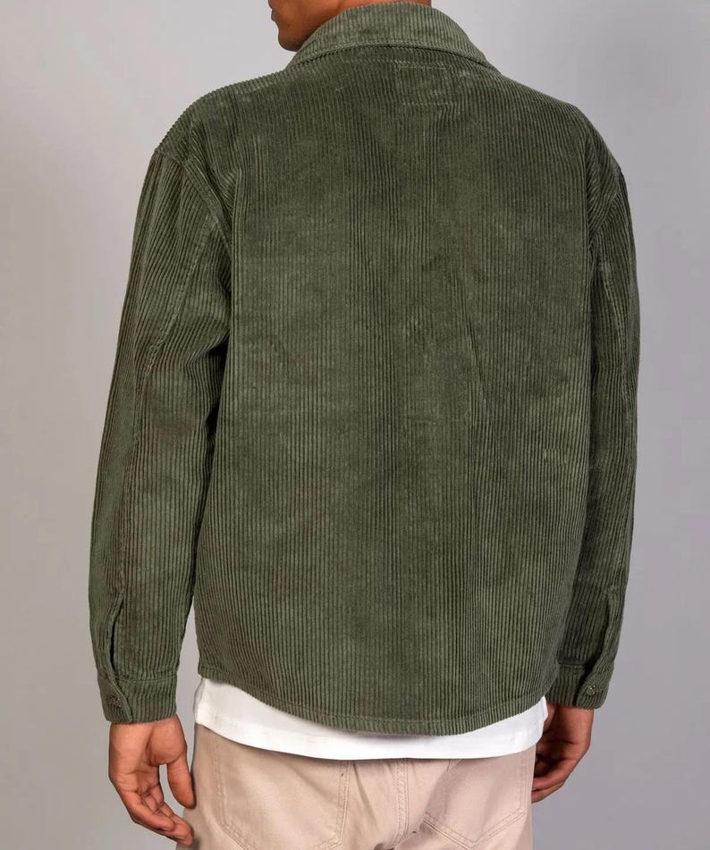 May include: A green corduroy shirt with a button-up front and long sleeves.