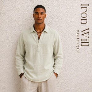 May include: A light sage green long-sleeve shirt with a partial button-down placket, a pointed collar, and a single chest pocket. The shirt is paired with light-colored trousers. The text Iron Will BOUTIQUE is visible on the right side.