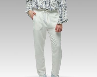 May include: White pants with a drawstring waist and a relaxed fit. The pants are made of a lightweight fabric and have a casual style.