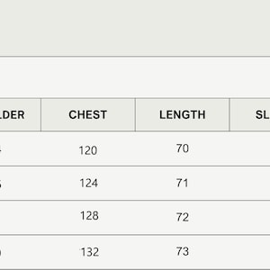 May include: Size chart for a garment with measurements in centimeters for shoulder, chest, length, sleeve, and bottom. Sizes include S, M, L, and XL.