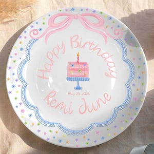 May include: A set of three ceramic mugs with a speckled, matte finish. The mugs are in shades of cream, light gray, and dark gray. Each mug has a simple, minimalist design and a rounded handle.