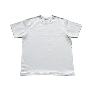 May include: A plain white short-sleeve t-shirt with a crew neckline. The garment features a small, rectangular red and white brand label stitched inside the center of the collar. The shirt has a standard fit with hemmed sleeves and a straight bottom hem.