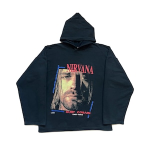 May include: Black hooded sweatshirt featuring a graphic of Kurt Cobain with the band name "NIRVANA" in red above his image. The text "KURT COBAIN 1967-1994" is printed below the image. The sweatshirt has long sleeves.