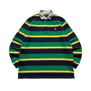 May include: A long-sleeve rugby shirt featuring horizontal stripes in navy blue, green, and yellow. The shirt has a white collar, a button-up placket, and a small yellow embroidered logo on the left chest. The label reads Polo Ralph Lauren.