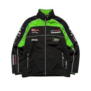 May include: A black and lime green zip-up jacket featuring the Speedfit Kawasaki logo on the chest and sleeve. The jacket includes multiple sponsor logos, a high collar, and two zippered pockets, with black as the primary color and green accents.