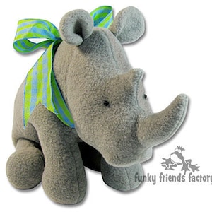 May include: A grey plush rhinoceros toy with a green and blue striped bow. The toy is sitting on a white background.