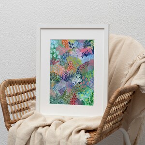 May include: A framed print of a colorful abstract painting featuring a variety of shapes and patterns in shades of blue, green, pink, and red. The painting depicts a stylized floral design with a whimsical and organic feel.