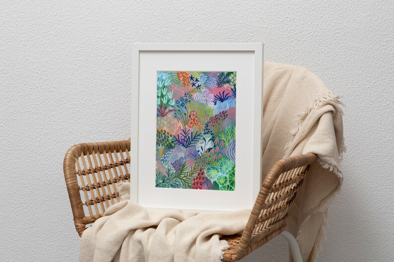 May include: A framed print of a colorful abstract painting featuring a variety of shapes and patterns in shades of blue, green, pink, and red. The painting depicts a stylized floral design with a whimsical and organic feel.
