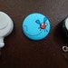 Orange Buzzing Fly Fabric Covered Button for Clip on Retractable Badge Reel