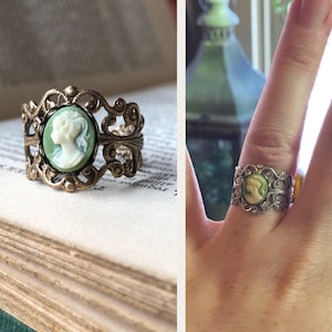 Antiqued brass and silver adjustable filigree ring in vintage-style with a green and cream small lady cameo set on a bezel.