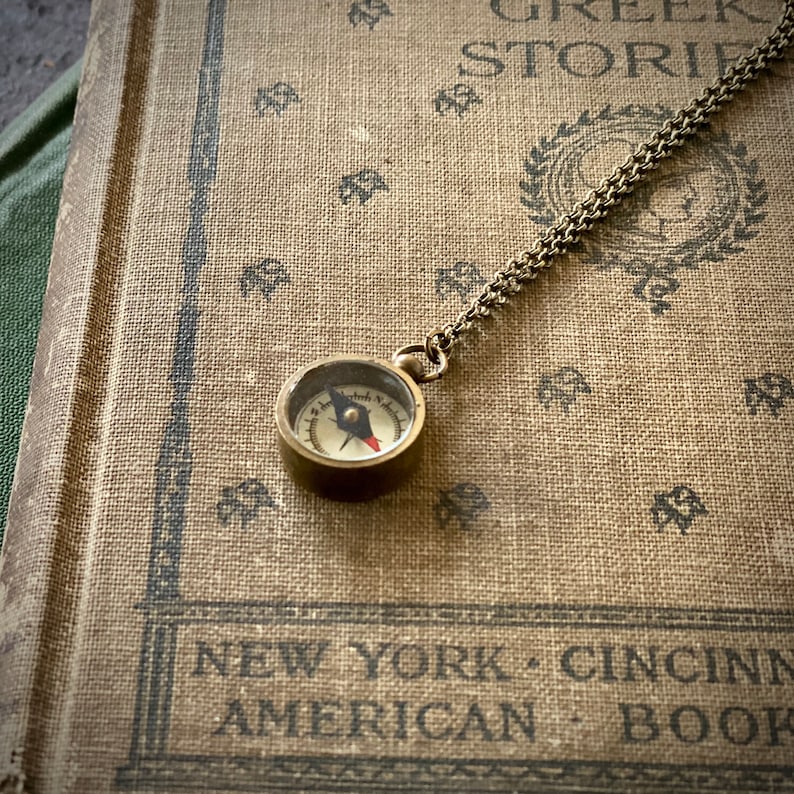 Antiqued brass working compass necklace. Makes a great gift for moving or graduation.