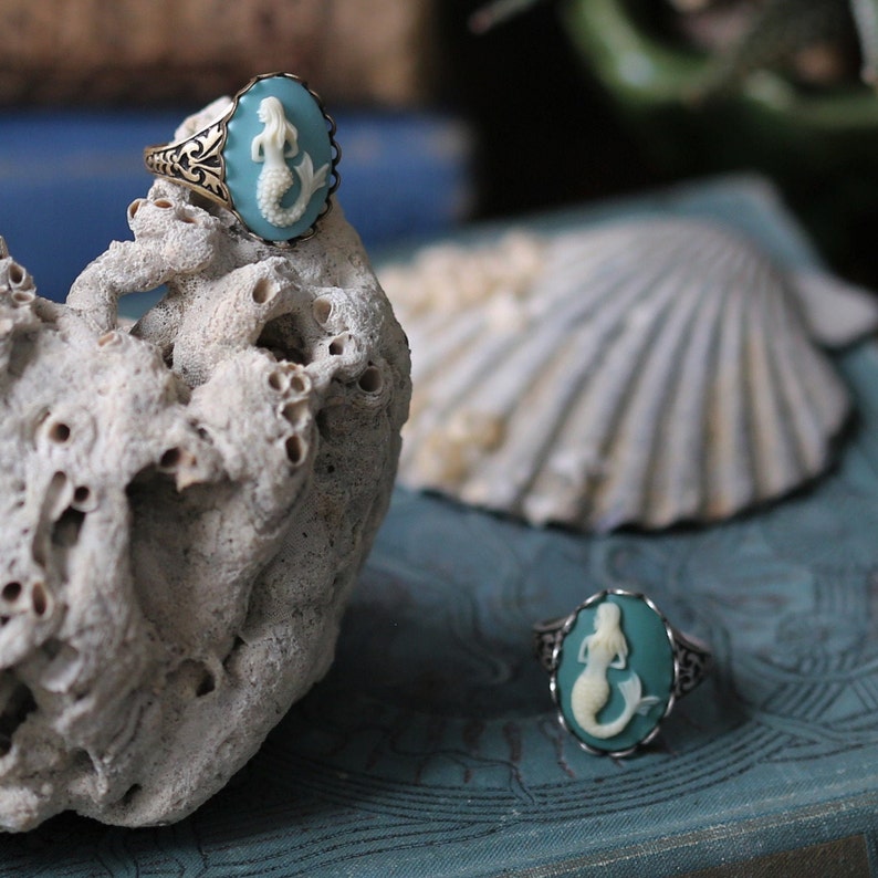 Antiqued silver and brass adjustable vintage style ring with a blue and cream mermaid cameo.