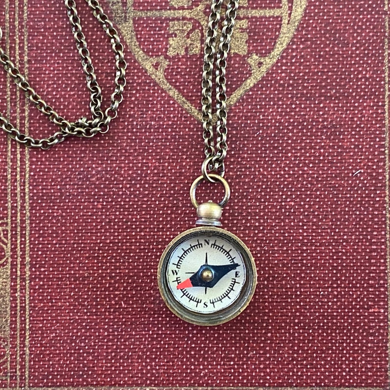 Antiqued brass working compass necklace. Makes a great gift for moving or graduation.