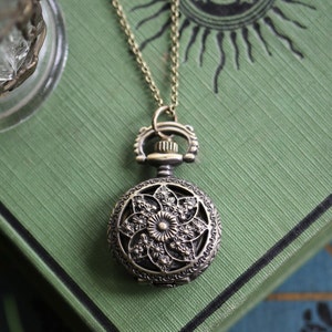 Pinwheel or Stars Battery Operated Pocket Watch Necklace in Antiqued Brass