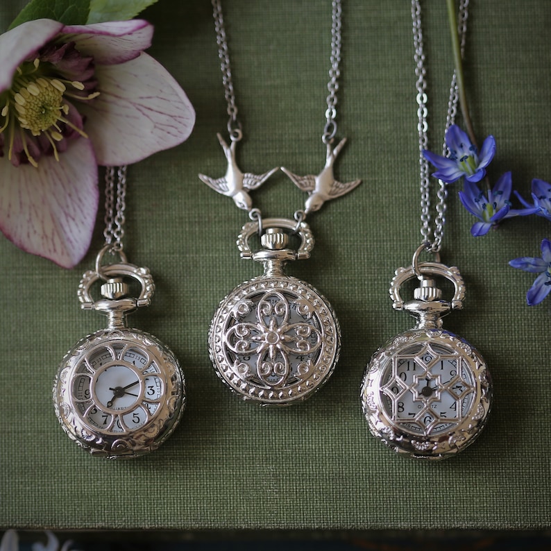 Silver watch with two bird connectors attached