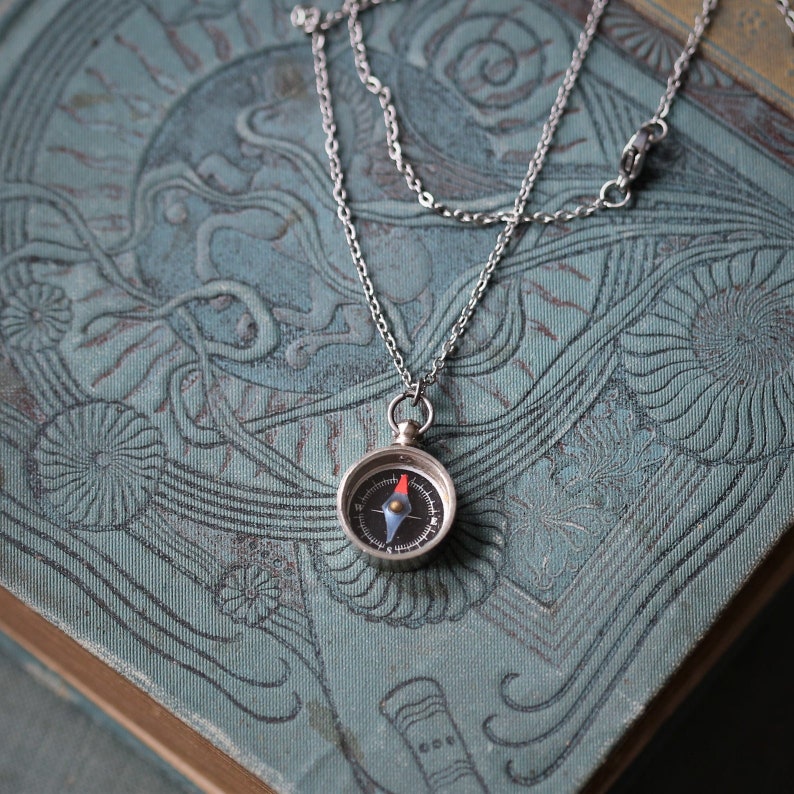 Silver working compass necklace. Makes a great gift for moving or graduation.