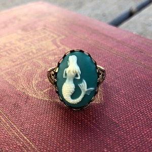 Antiqued brass adjustable vintage style ring with a blue and cream mermaid cameo.