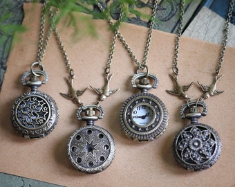May include: Four antique-style pocket watches on chains with bird charms. The watches have different designs, including a star pattern, a floral pattern, and a clock face. The chains are silver and the charms are gold.
