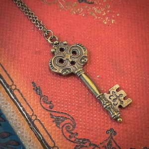 Antiqued brass skeleton key necklace in vintage style.