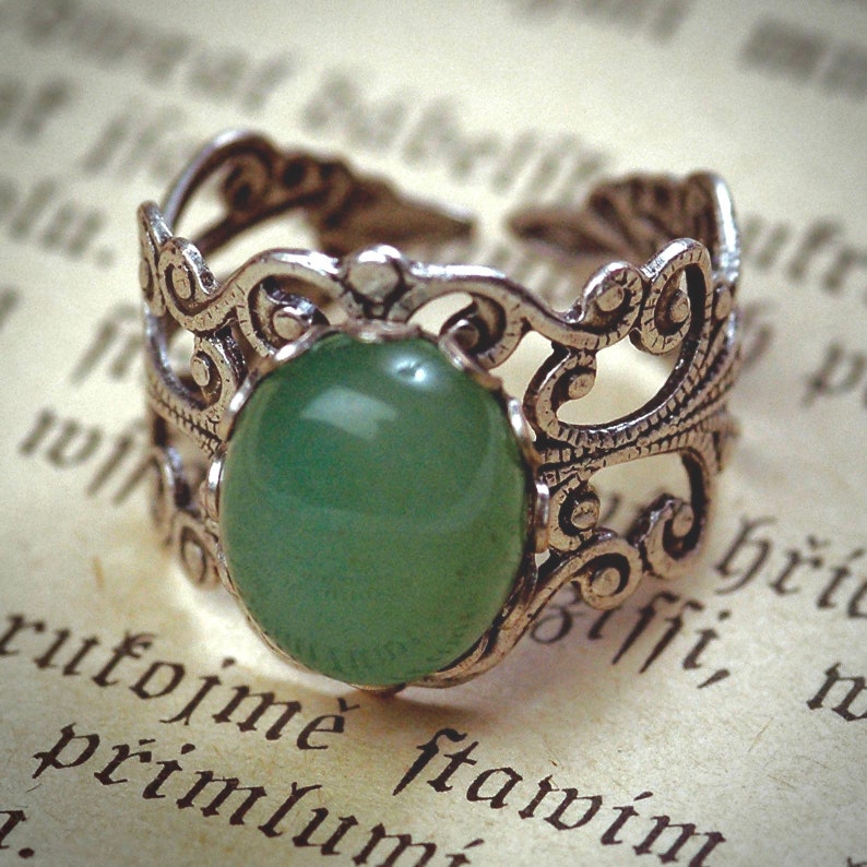 Sage green aventurine stone mineral cabochon on and antiqued brass adjustable filigree ring in vintage=style.