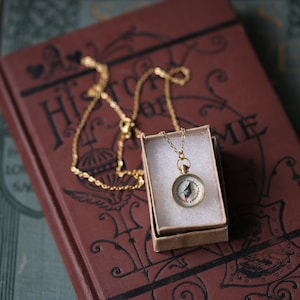 Gold tone working compass necklace. Makes a great gift for moving or graduation.