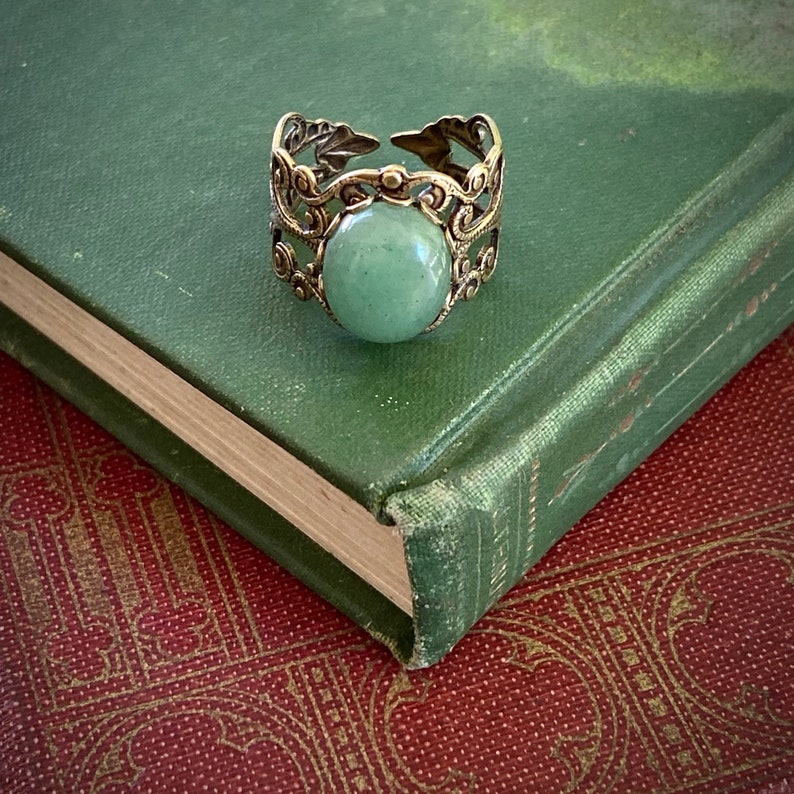 Sage green aventurine stone mineral cabochon on and antiqued brass adjustable filigree ring in vintage=style.