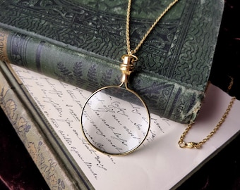 Collier loupe monocle en verre doré